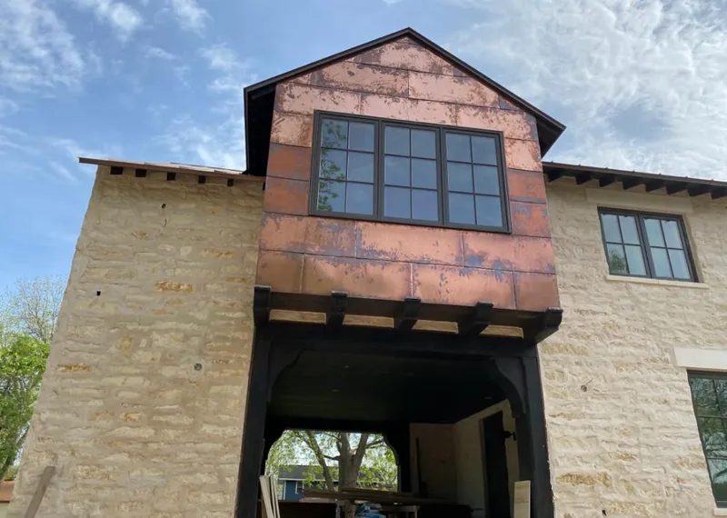 Copper metal panel facade on a stone building for Roof Repair in Fishers